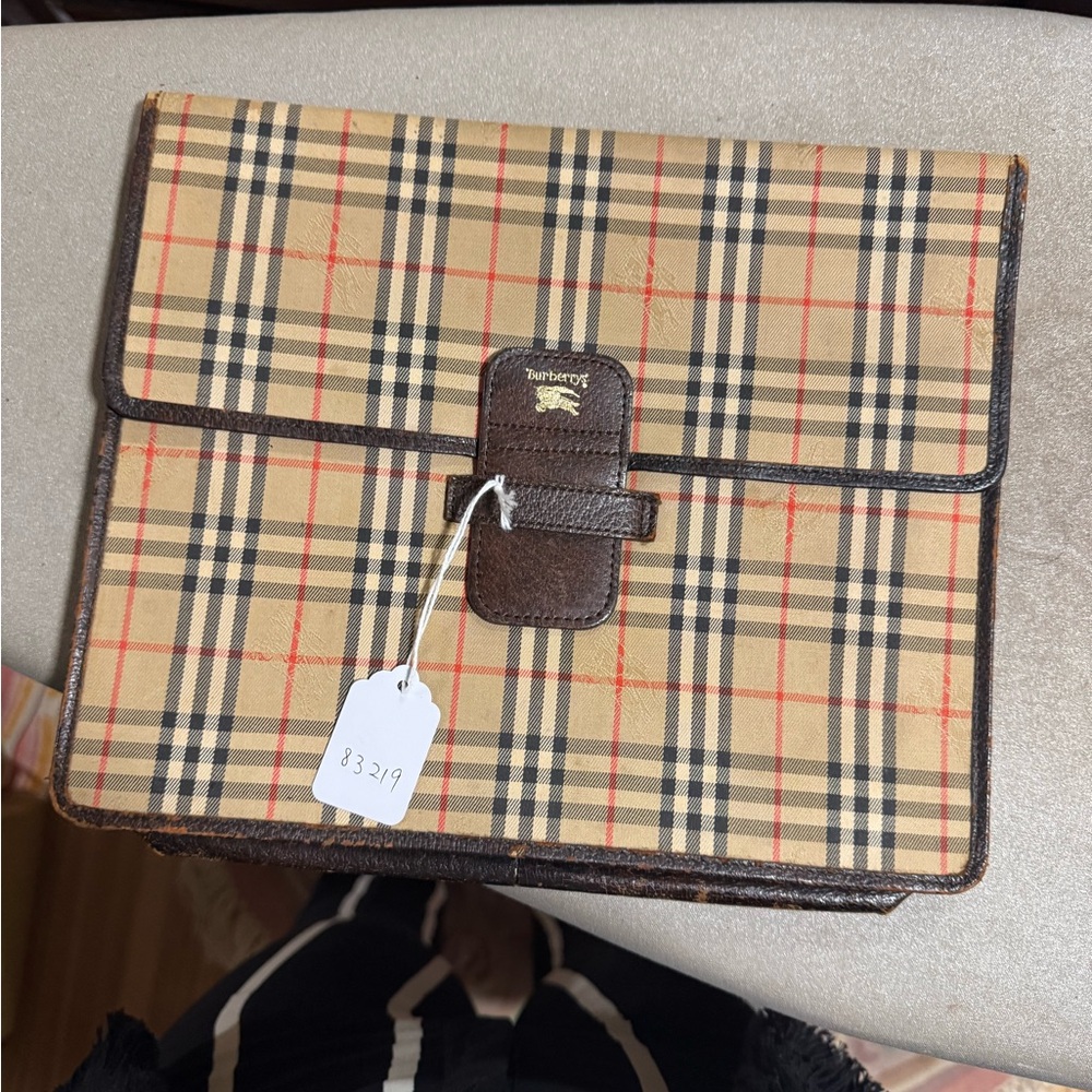 Burberry Tan and Brown clutch. Nice and large for your everyday use.
